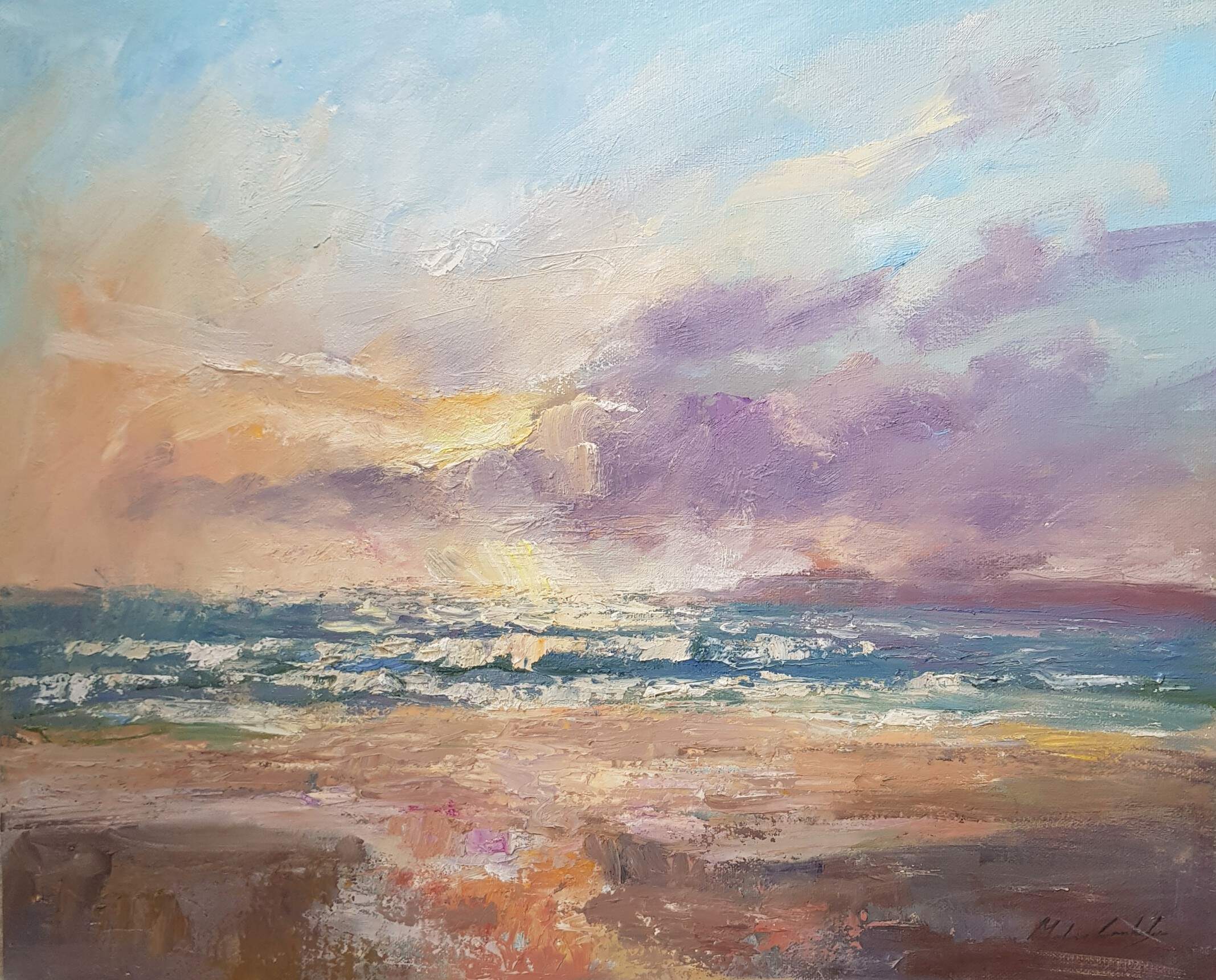 Seascape with sun lighting breaking surf onto a beach with a cloudy sky