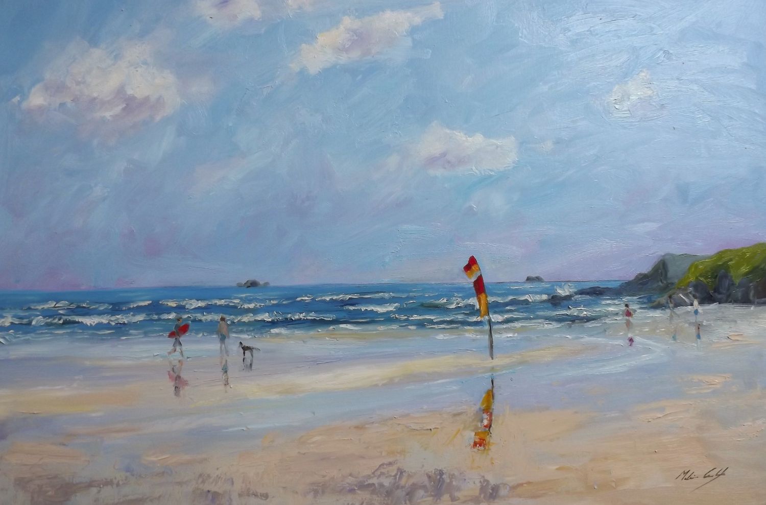Surfers and flags on the beach at Constantine Bay